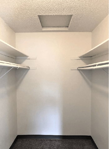 Empty white shelves in a small room.